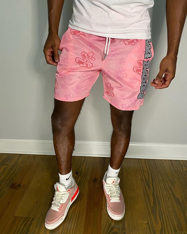 man wearing a pair of Sneakers  with pink shorts