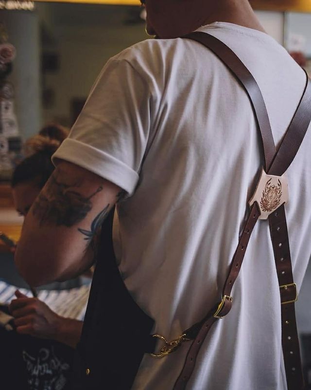 Man with a tattoo wearing brown leather X-Back Suspenders