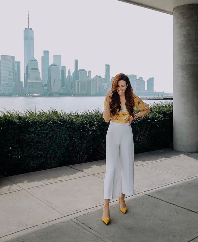 woman wearing Yellow tops and heels with white pants