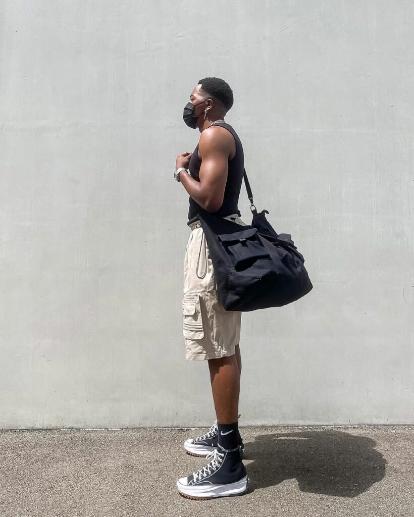 man with bag and cargo shorts