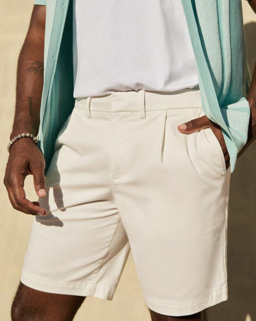 Man wearing button-down shirt and white shorts