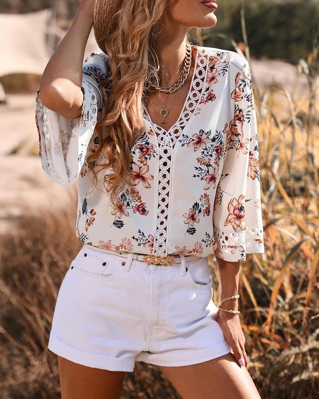 Girl wearing floral blouse with  white shorts
