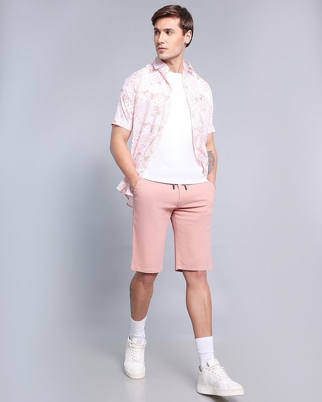 man wearing pink shorts with floral shirt