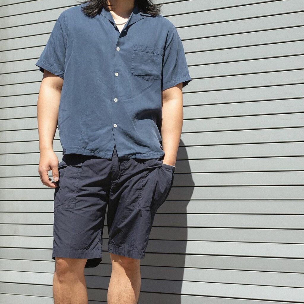 man wearing blue short-sleeve button-down shirt with cargo shorts