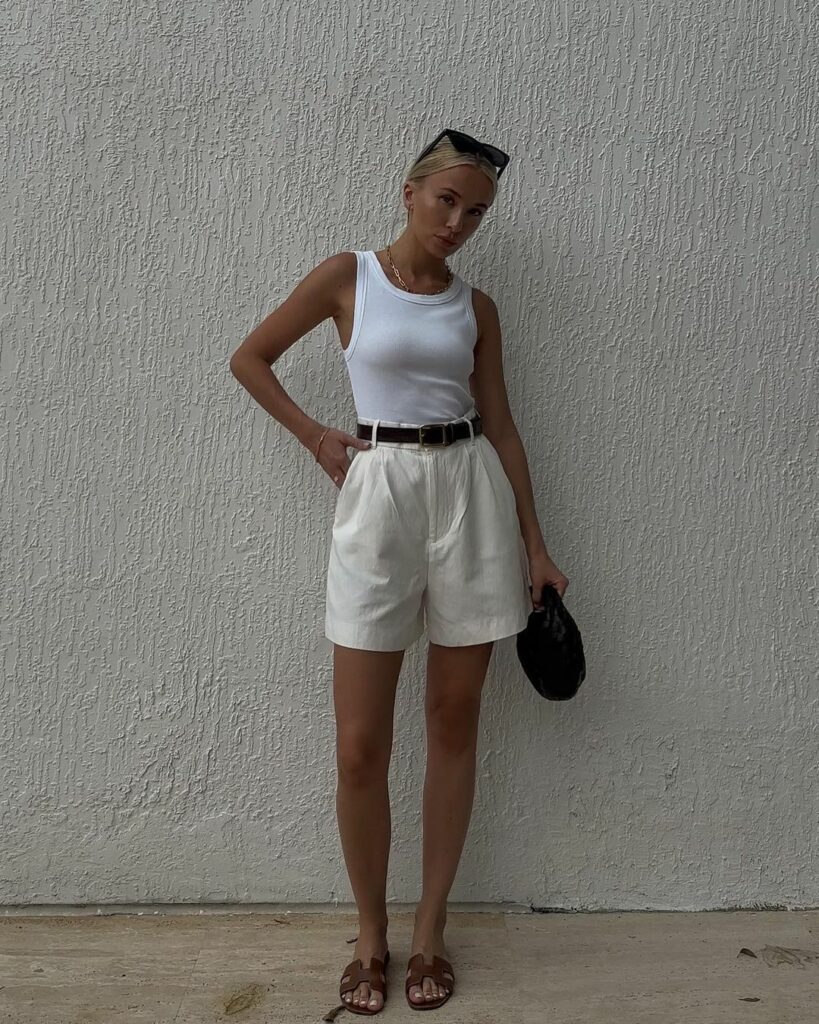 Woman wearing sleeveless tops with white shorts
