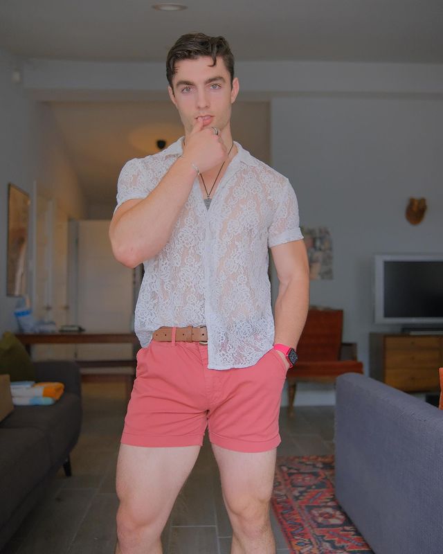 Man wearing pink shorts with white shirt