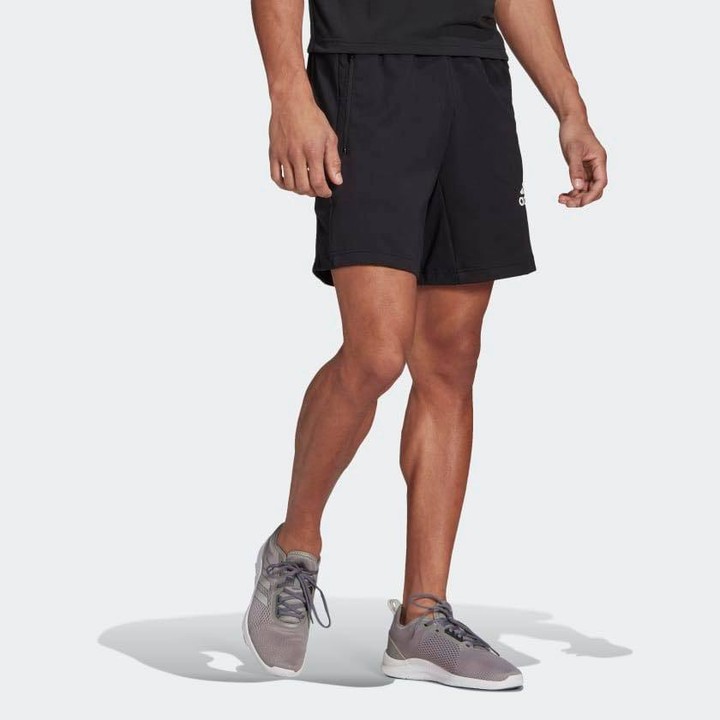man wearing grey Sneakers with black shorts