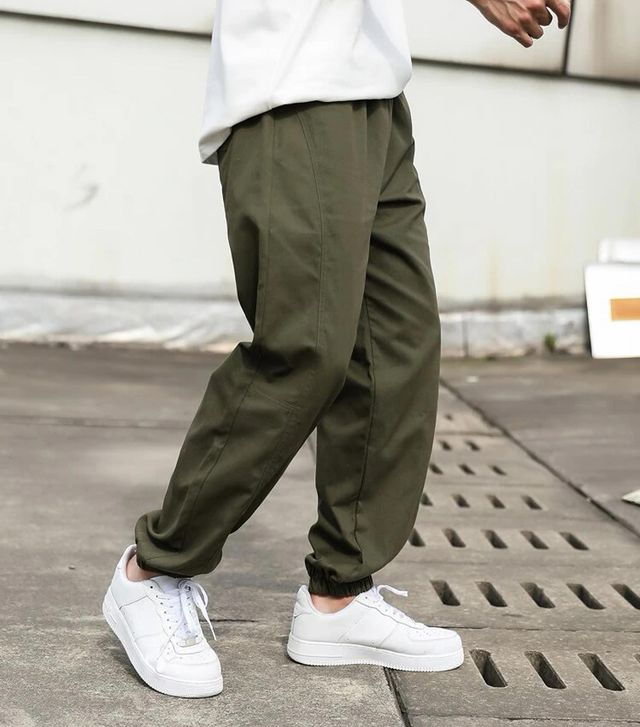 man in Tapered Slacks and white shoe