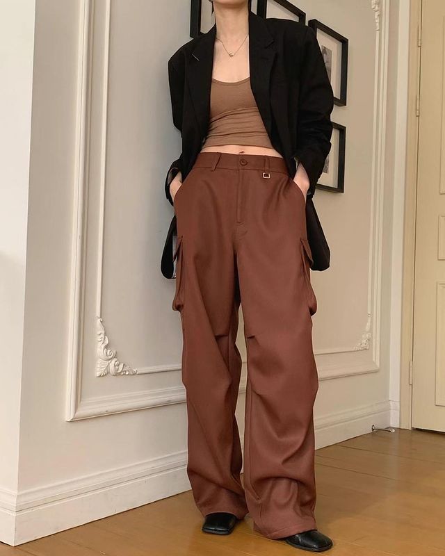 Woman in black blazer  and cargo pants