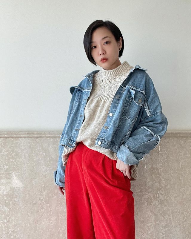 Girl wearing blue denim jacket with red pants