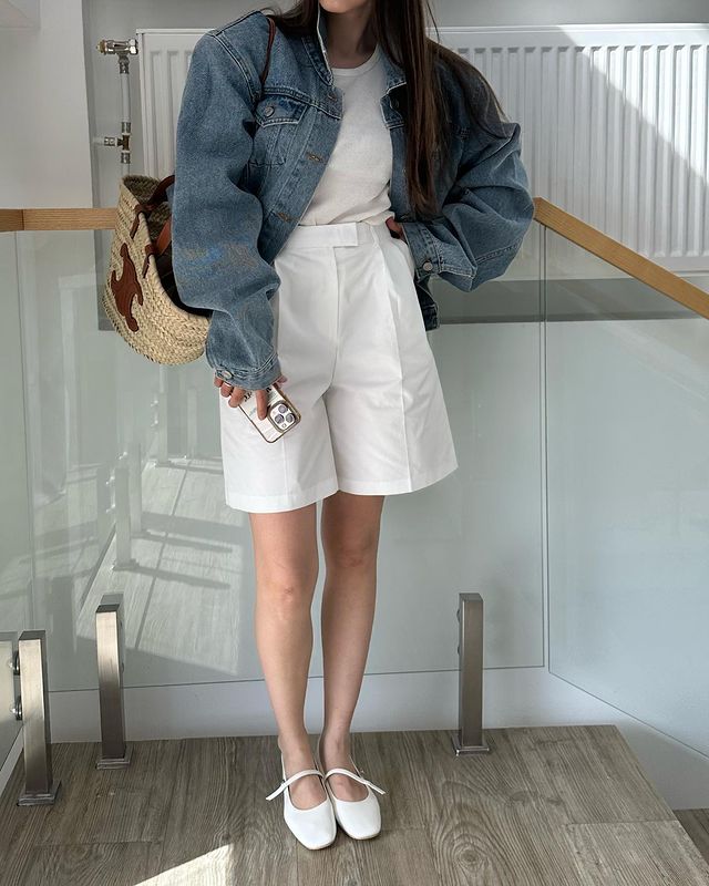Girl wearing denim jacket  with  white shorts