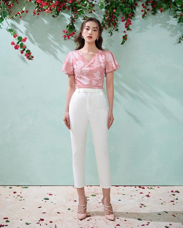woman wearing floral printed tops with white pants