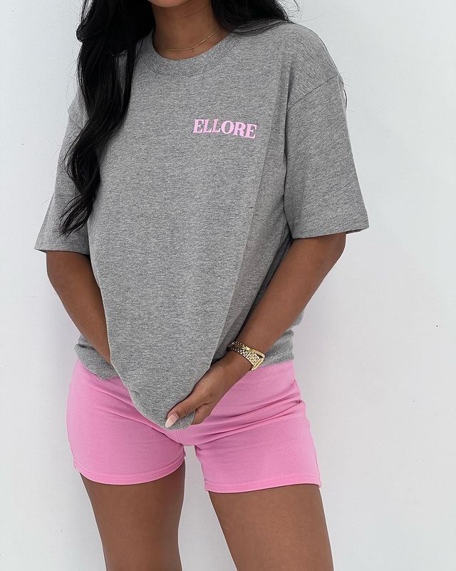girl wearing gray tops with pink shorts