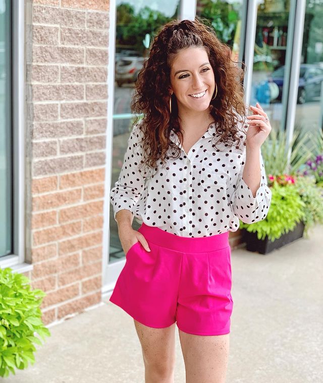 Woman wearing patterned tops with pink shorts