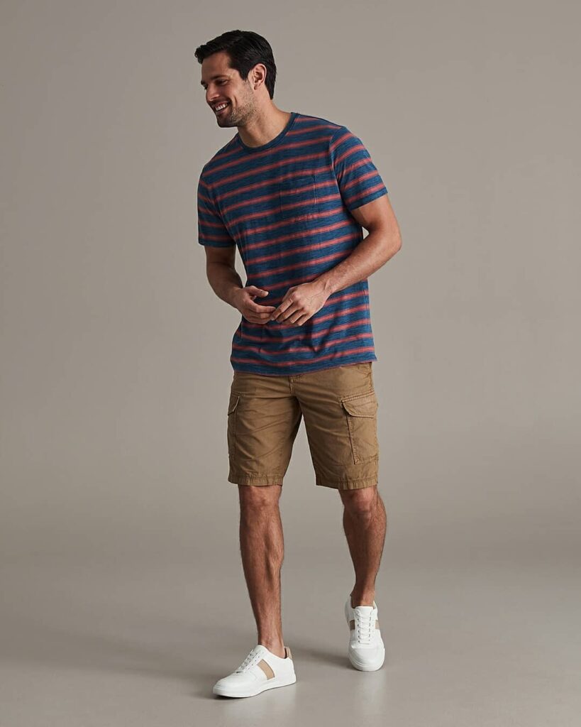 man wearing striped t-shirt with cargo shorts